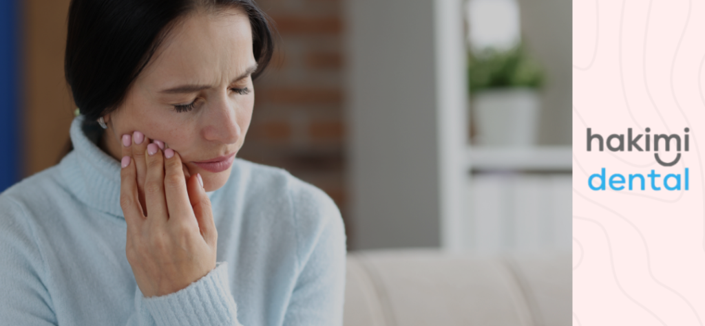 bite inside of cheek - woman in pain applying pressure on her cheek